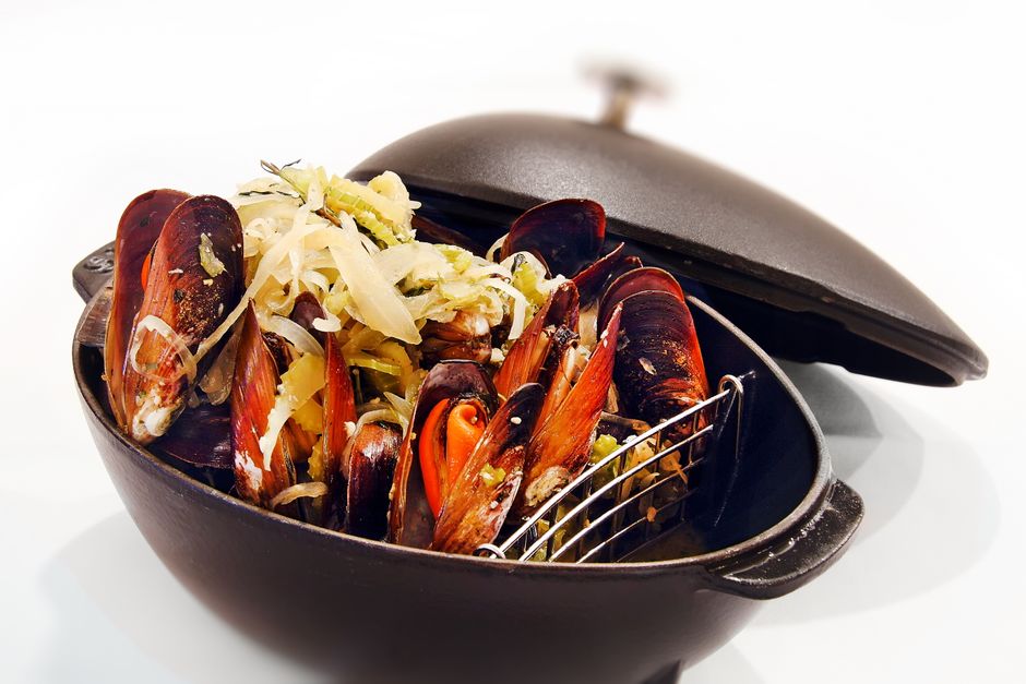 Cooked mussels with open shells in a pot